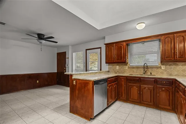 a kitchen with a stove sink and cabinets