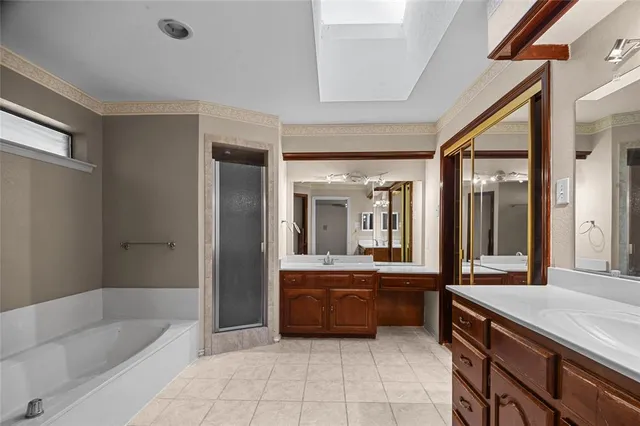 a bathroom with a tub sink and mirror