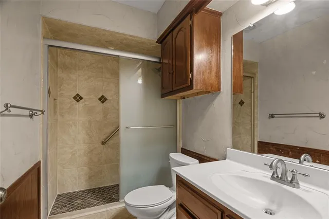 a bathroom with a sink toilet and shower