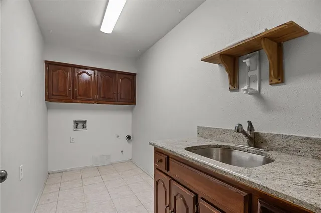 a kitchen with a sink and cabinets