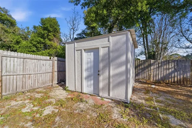 a backyard of a house with a tree