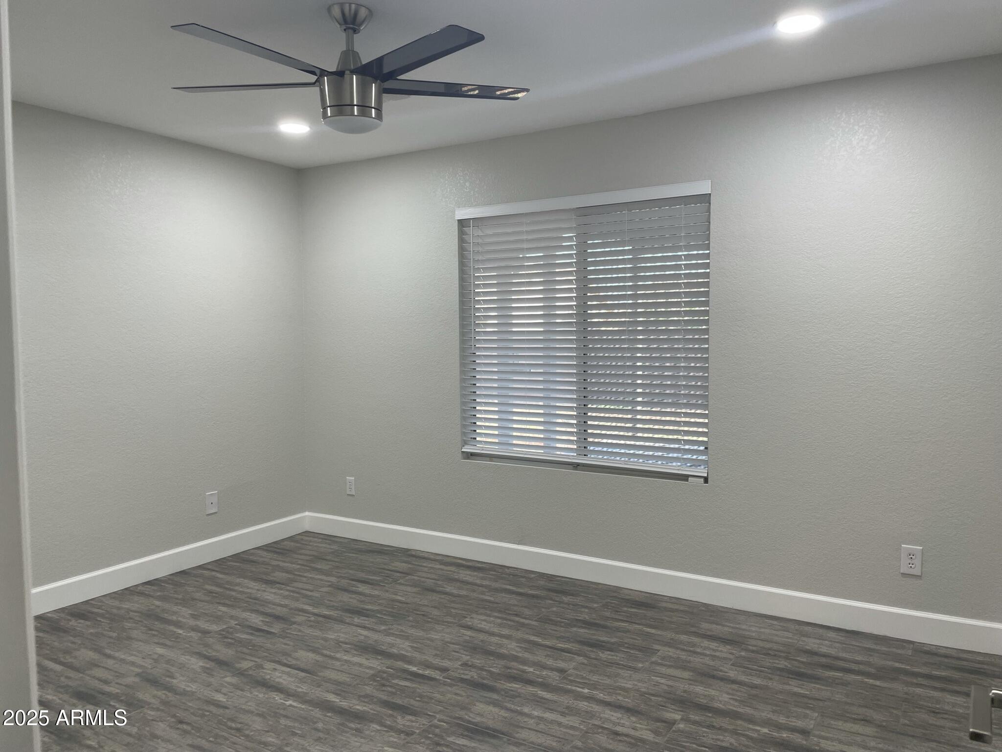 839 West 12th Avenue Apache Junction, AZ 85120 - Photo 11 of 26 wooden floor in an empty room with a window