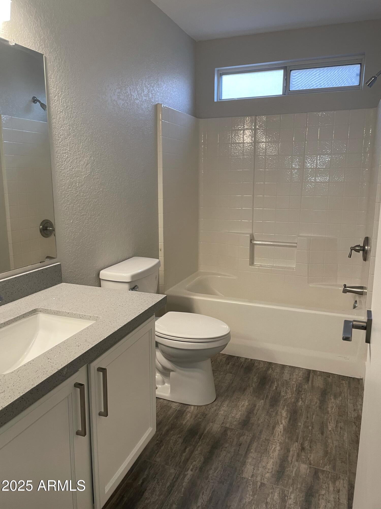 839 West 12th Avenue Apache Junction, AZ 85120 - Photo 14 of 26 a bathroom with a granite countertop toilet a sink and bathtub