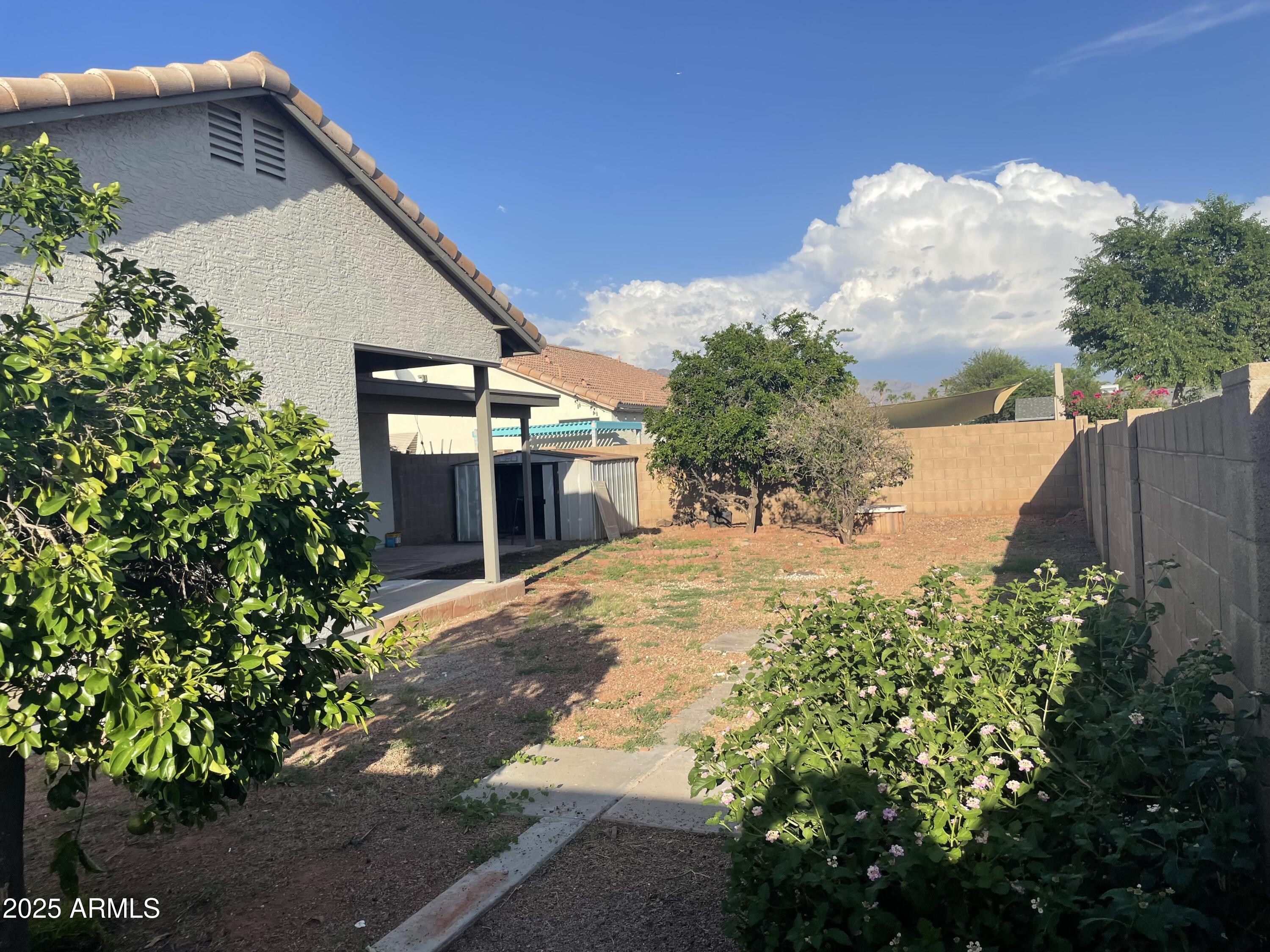 839 West 12th Avenue Apache Junction, AZ 85120 - Photo 23 of 26 a pathway of a house with potted plants and big yard
