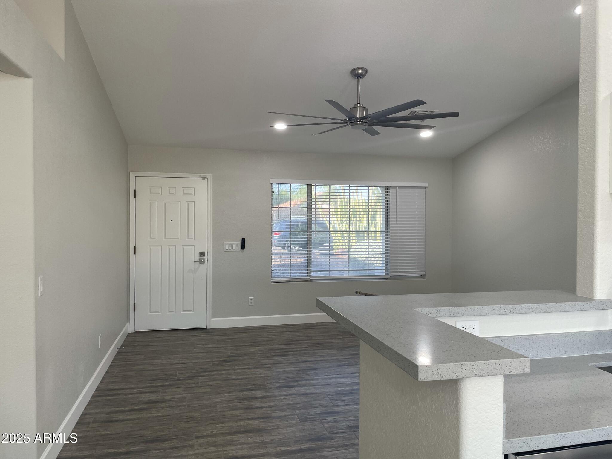 839 West 12th Avenue Apache Junction, AZ 85120 - Photo 3 of 26 a view of an empty room with window and wooden floor
