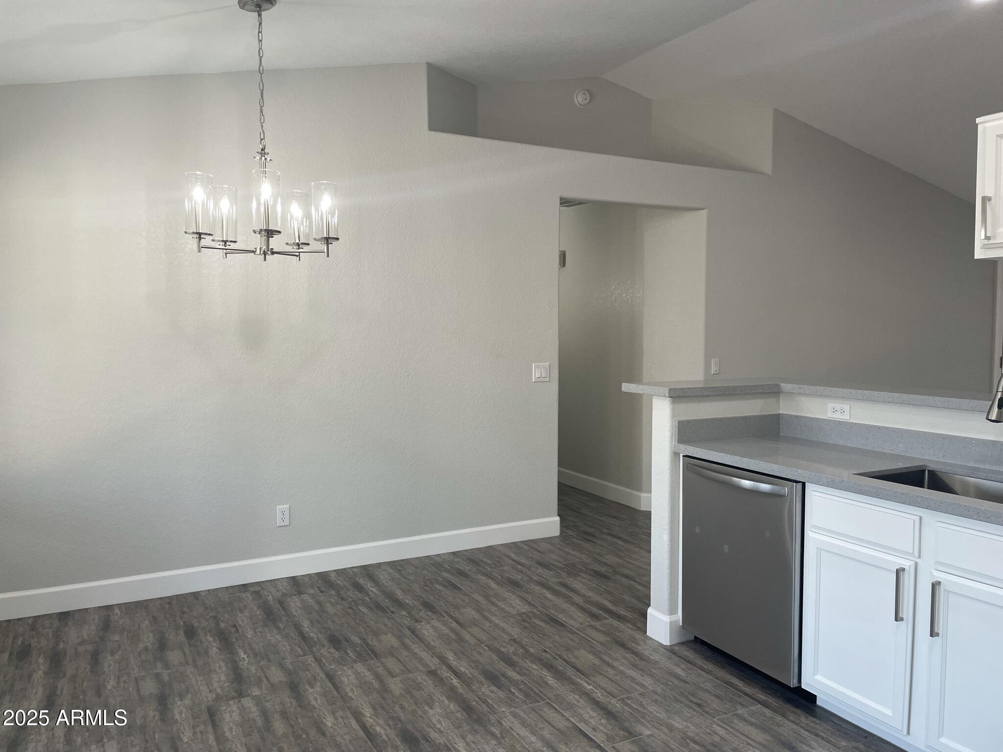 839 West 12th Avenue Apache Junction, AZ 85120 - Photo 6 of 26 a view of a kitchen with a dishwasher and a wooden floor