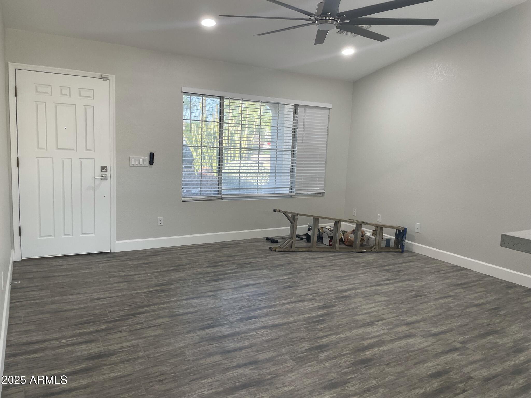 839 West 12th Avenue Apache Junction, AZ 85120 - Photo 7 of 26 wooden floor in an empty room with a window