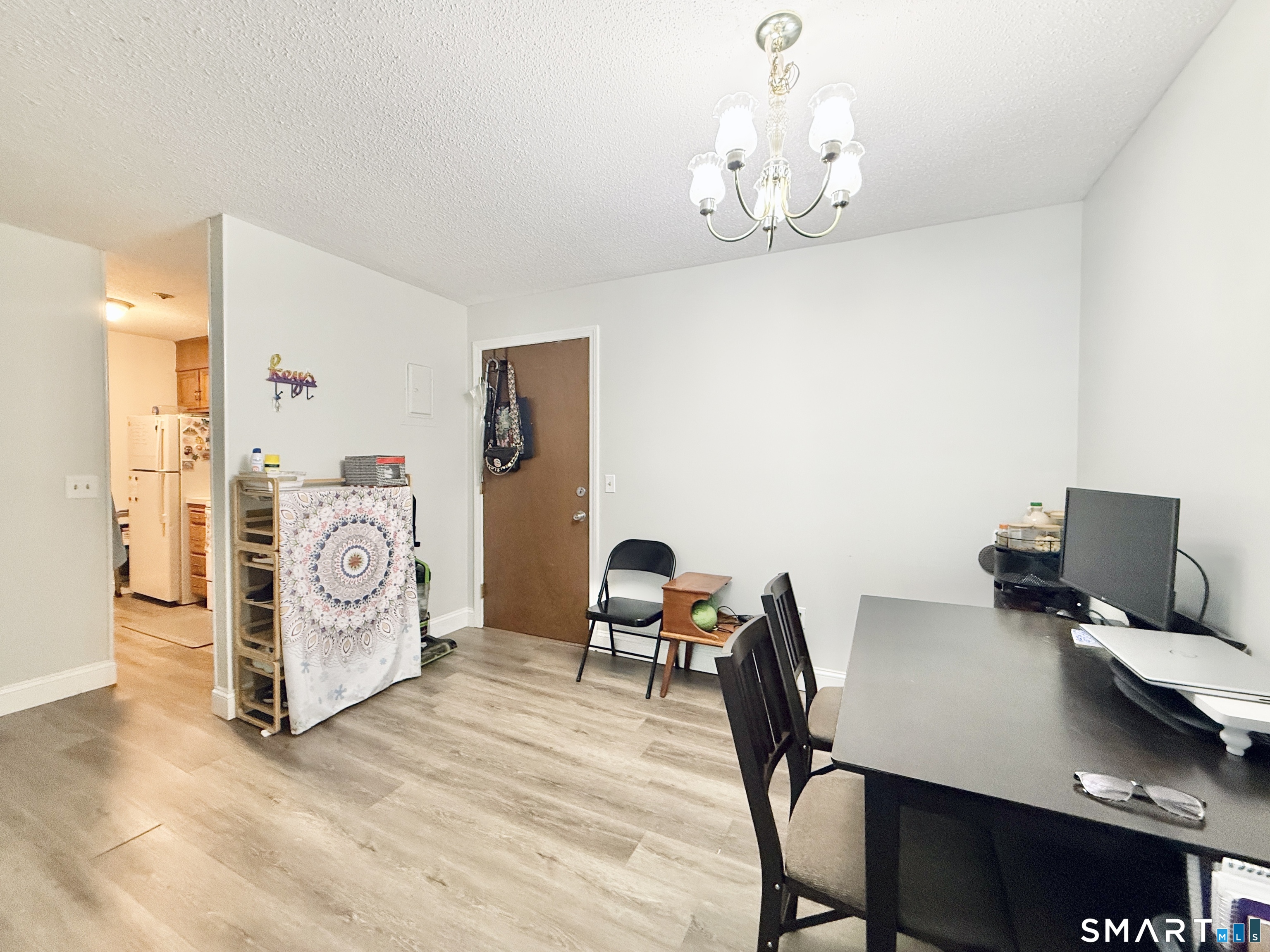 34 A Padanaram Road, Unit 127 Danbury, CT 06811 - Photo 5 of 13 a workspace with furniture and chandelier
