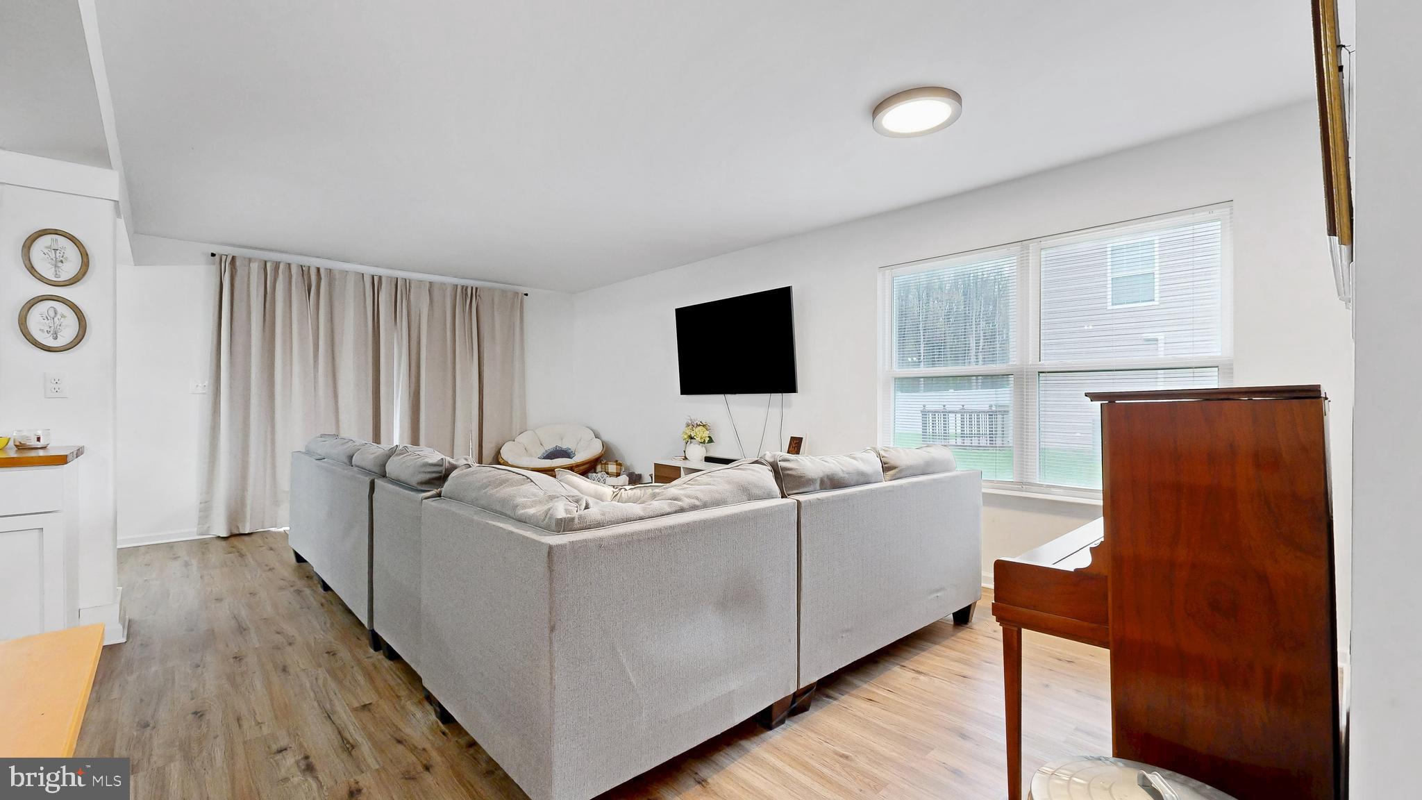 433 East Wind Drive Dover, DE 19901 - Photo 11 of 61 a living room with furniture and a flat screen tv