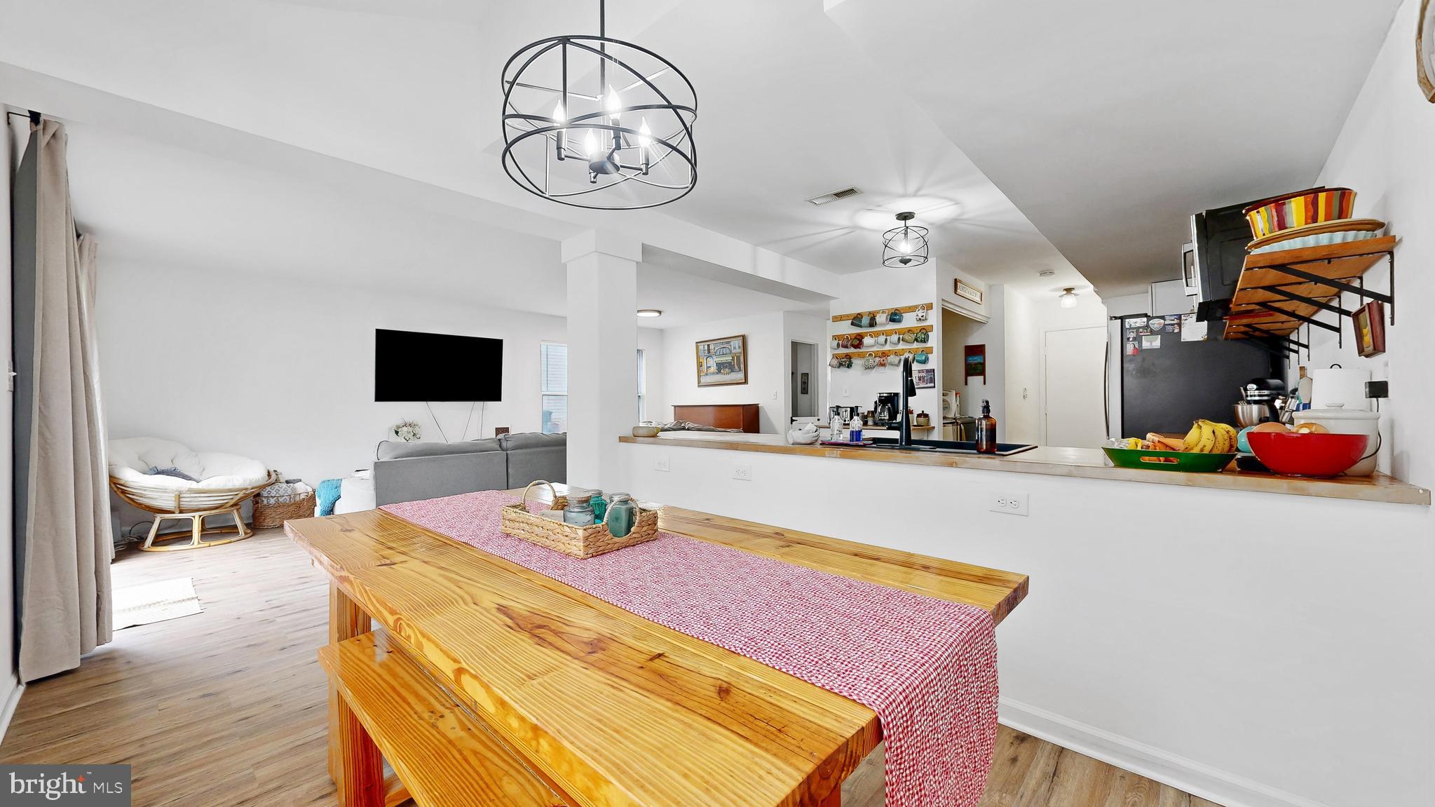 433 East Wind Drive Dover, DE 19901 - Photo 15 of 61 a dining room with wooden floor and chandelier