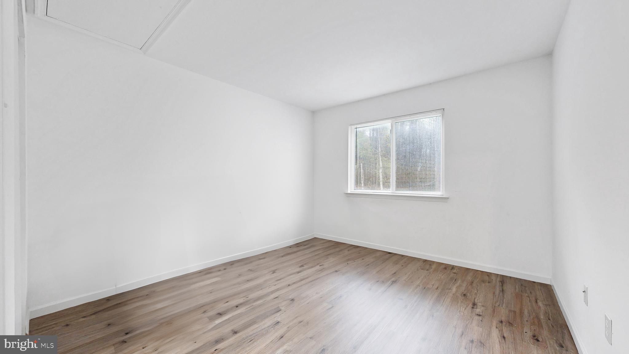 433 East Wind Drive Dover, DE 19901 - Photo 45 of 61 an empty room with wooden floor and windows