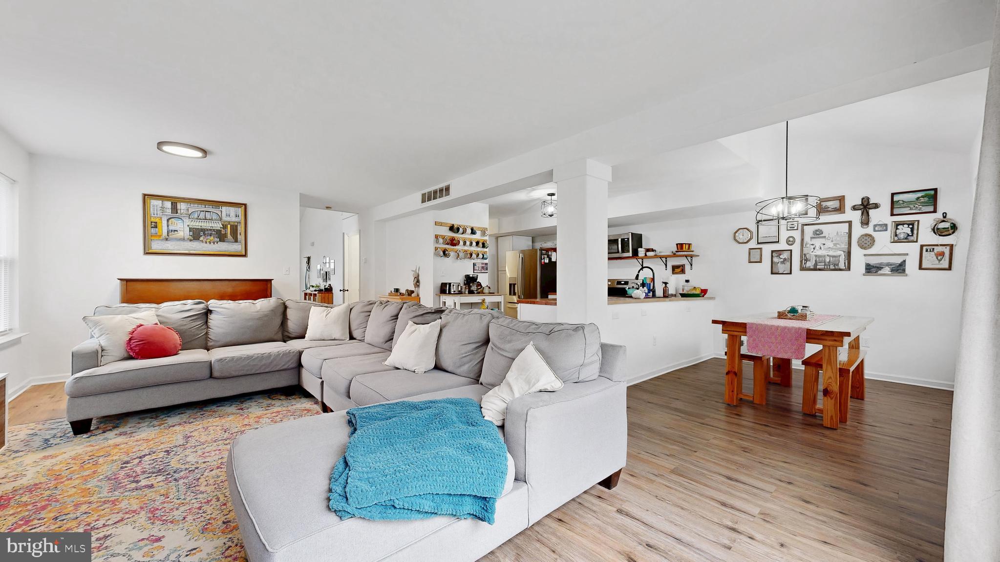 433 East Wind Drive Dover, DE 19901 - Photo 9 of 61 a living room with furniture wooden floor and wall paintings