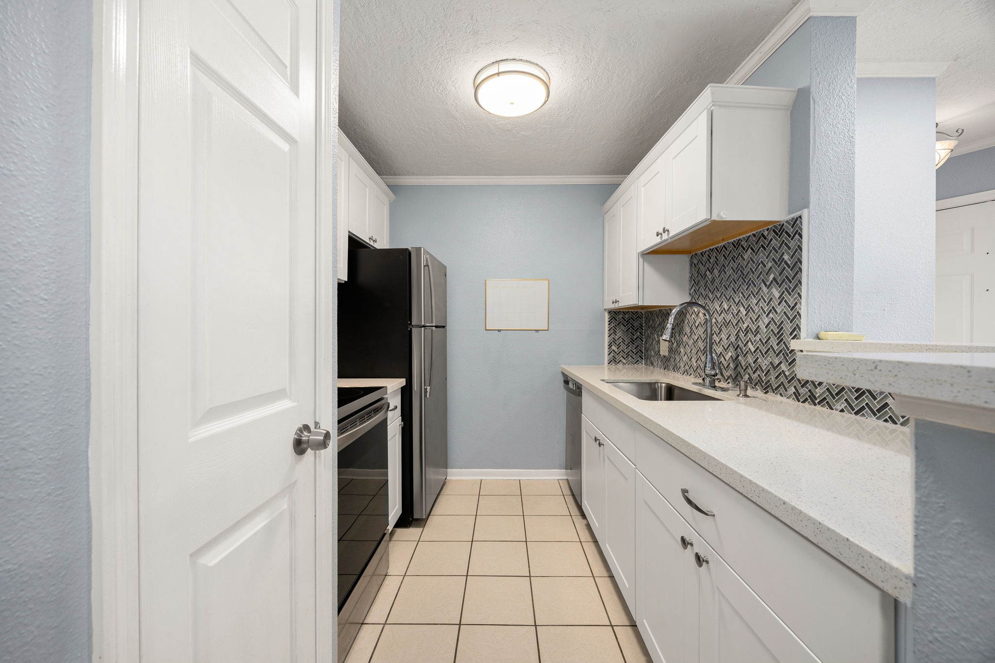 2121 Hepburn Street, Unit 710 Houston, TX 77054 - Photo 13 of 35 a kitchen with a sink stove and refrigerator
