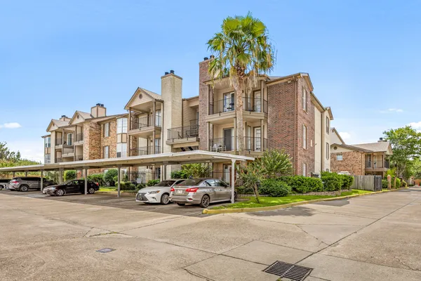 a front view of building with cars parked