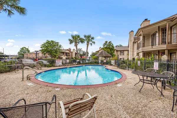 a view of outdoor space with swimming pool and sitting area