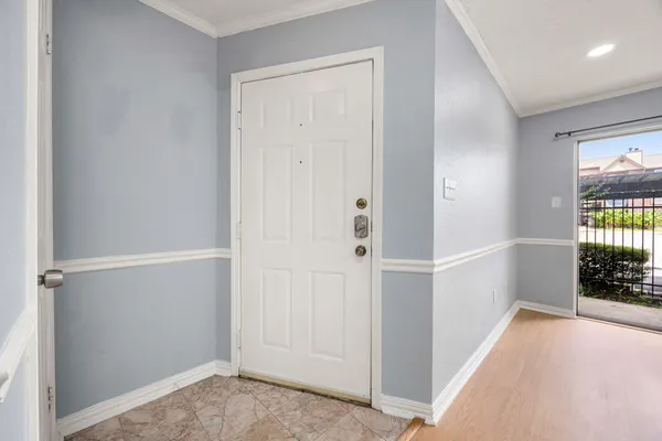 a view of hallway with wooden floor and a window
