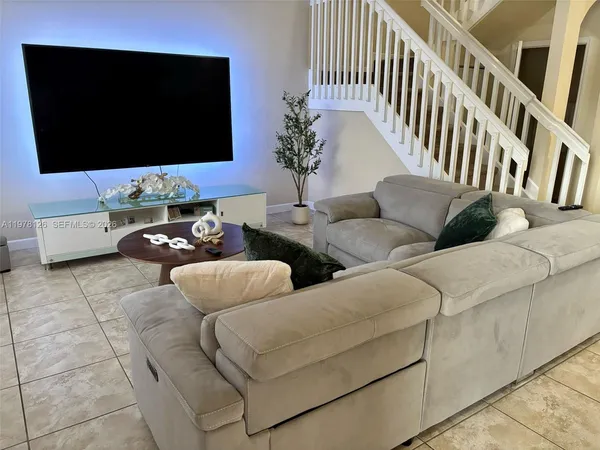 a living room with furniture and a flat screen tv