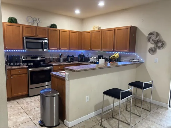 a kitchen with a sink cabinets and appliances