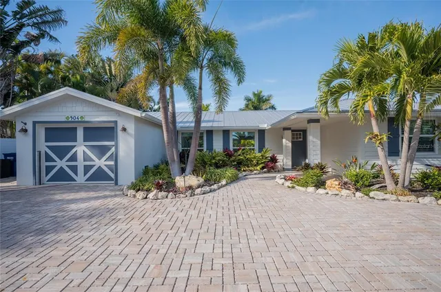 a front view of a house with a yard and a garage