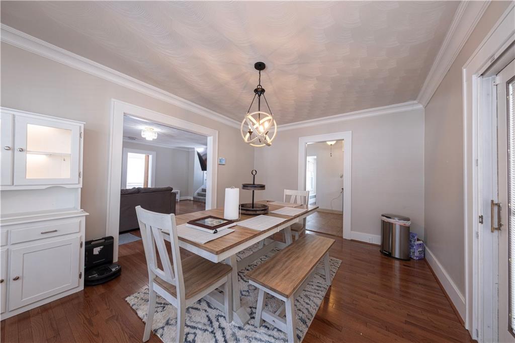61 West Prospect Avenue Washington, PA 15301 - Photo 14 of 47 a dining room with wooden floor a chandelier a wooden table and chairs