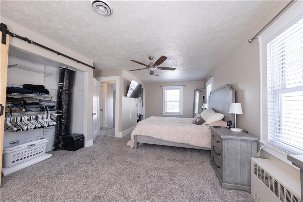 61 West Prospect Avenue Washington, PA 15301 - Photo 22 of 47 a bedroom with a bed and a chandelier