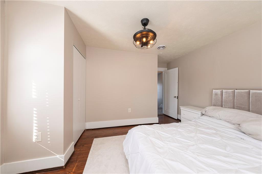 61 West Prospect Avenue Washington, PA 15301 - Photo 25 of 47 a bedroom with a bed and a chandelier