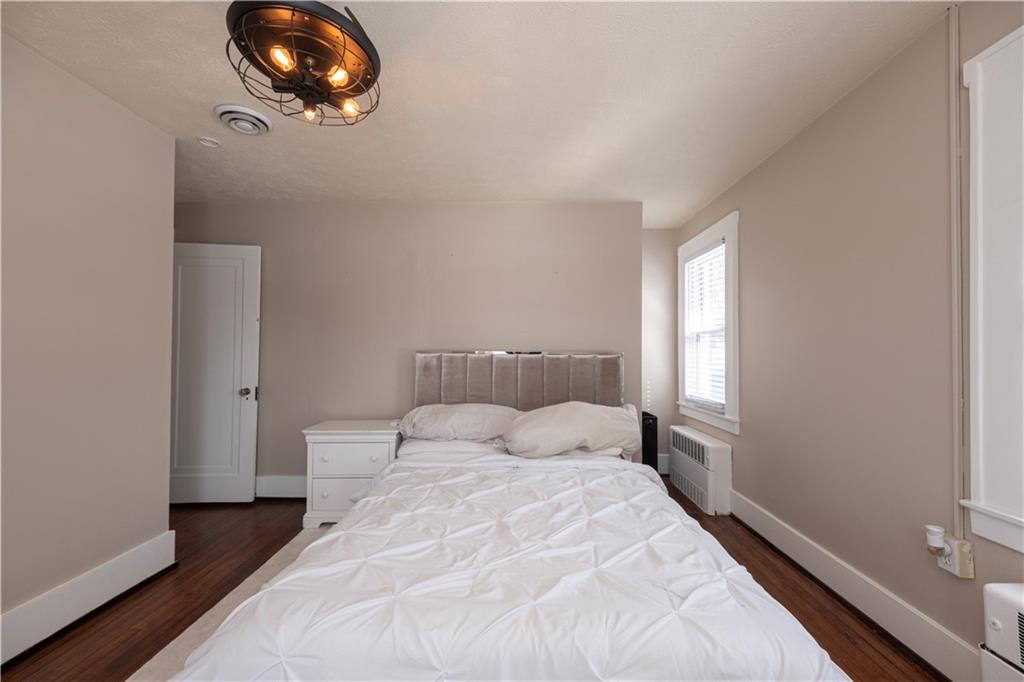 61 West Prospect Avenue Washington, PA 15301 - Photo 26 of 47 a bedroom with a bed and painting on the wall