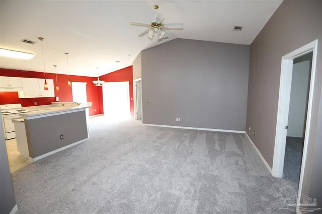 a view of a room with a window and a kitchen