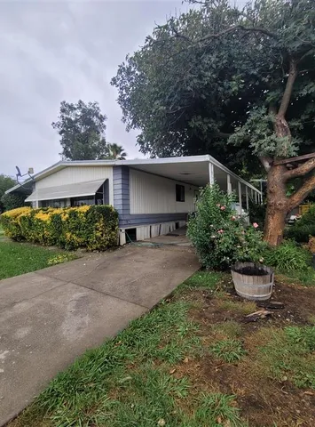 a front view of a house with potted plants