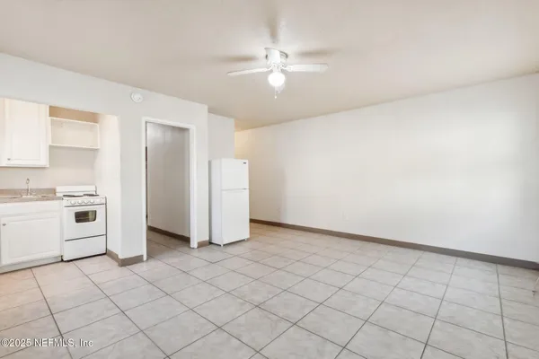 a view of a kitchen with white cabinets and white appliances