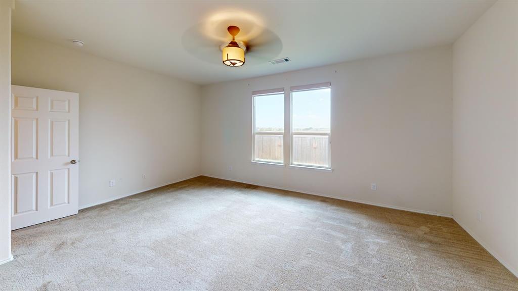 2213 Heaton Street Forney, TX 75126 - Photo 8 of 14 Carpeted room with neutral wall tones and a six-panel door