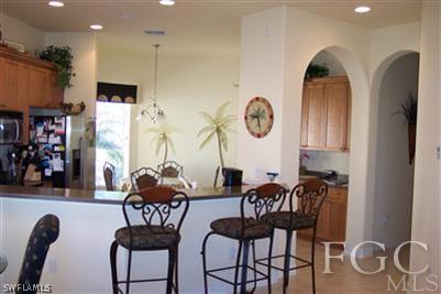 20076 Saraceno Drive Estero, FL 33928 - Photo 2 of 8 a dining room with furniture and wooden floor