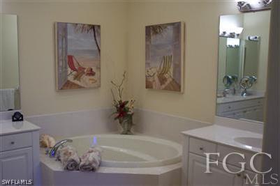 20076 Saraceno Drive Estero, FL 33928 - Photo 3 of 8 a bath tub sitting next to a bathroom sink