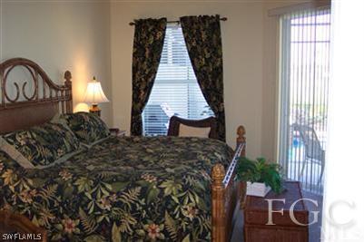 20076 Saraceno Drive Estero, FL 33928 - Photo 4 of 8 a bed sitting in a bedroom next to a window