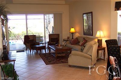 20076 Saraceno Drive Estero, FL 33928 - Photo 6 of 8 a living room with furniture a lamp and a large window
