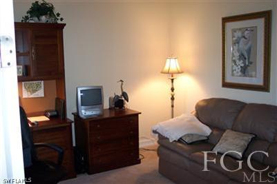 20076 Saraceno Drive Estero, FL 33928 - Photo 7 of 8 a living room with furniture and a lamp
