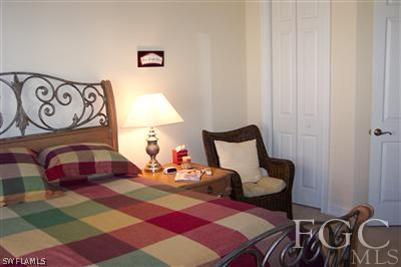 20076 Saraceno Drive Estero, FL 33928 - Photo 8 of 8 a bedroom with a bed and wooden floor