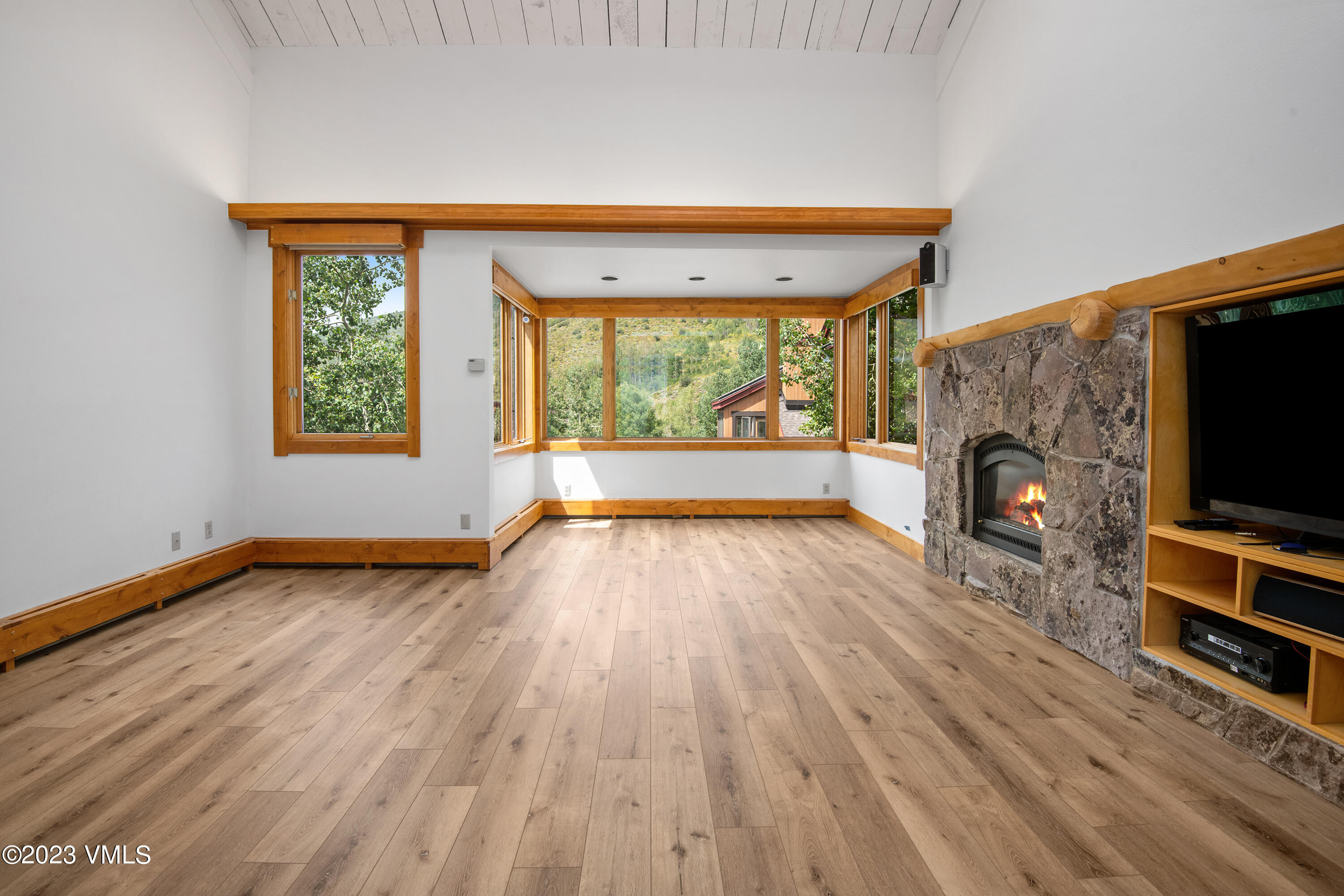 wooden floor in an empty room with a window