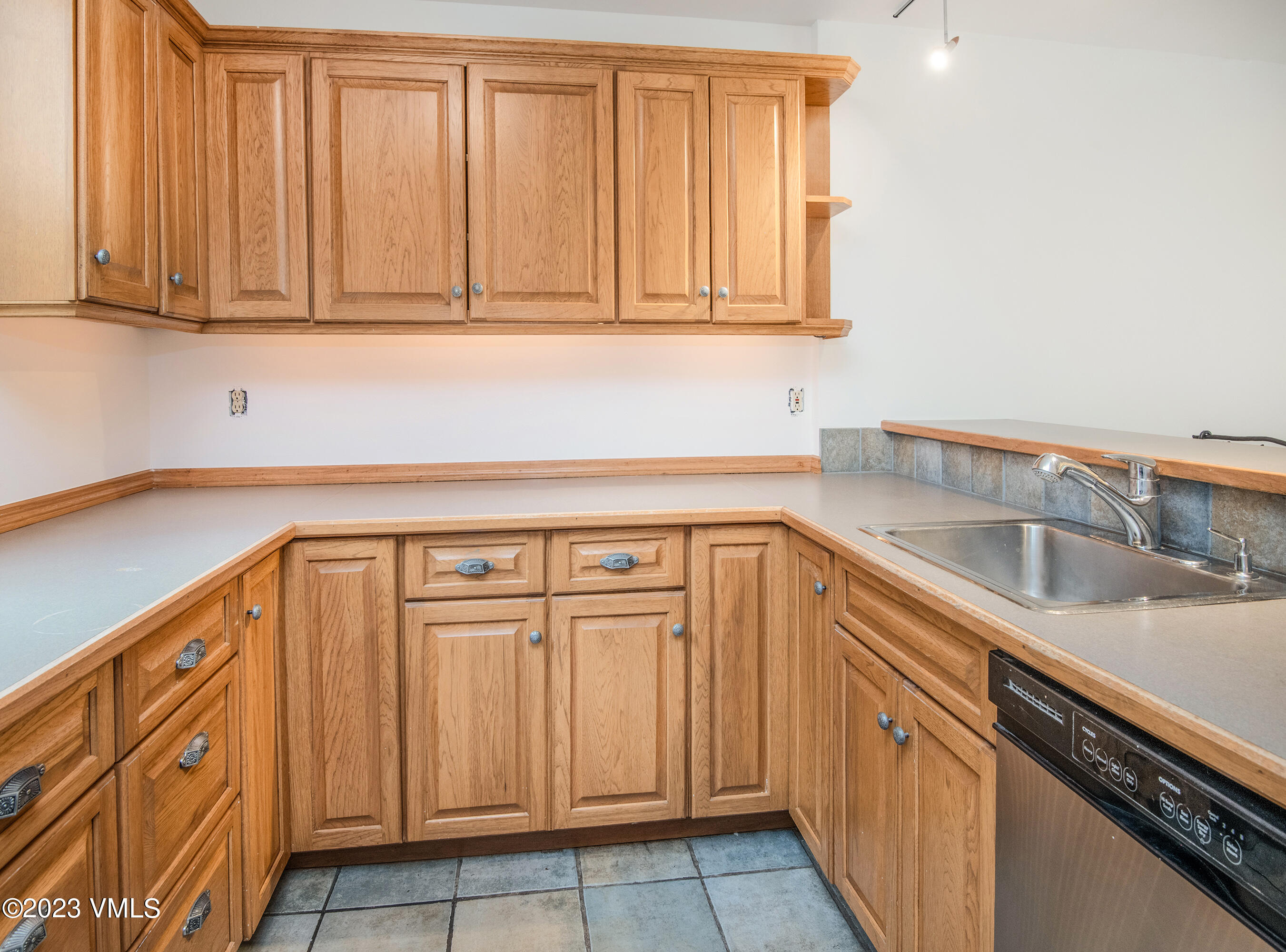 3094 Booth Falls Road, Unit 17 Vail, CO 81657 - Photo 11 of 27 a kitchen with granite countertop white cabinets and sink