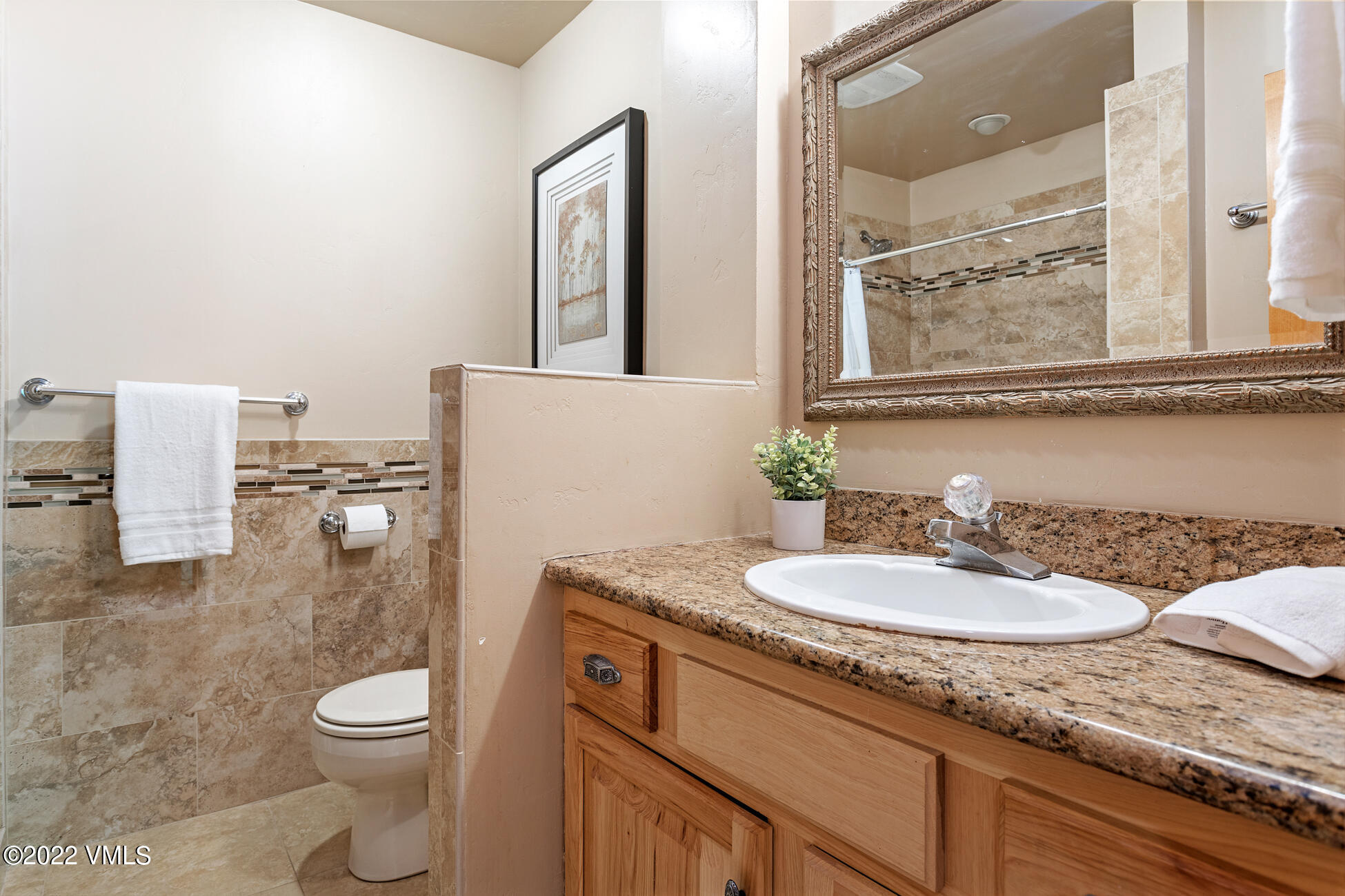 3094 Booth Falls Road, Unit 17 Vail, CO 81657 - Photo 18 of 27 a bathroom with a granite countertop sink mirror vanity and toilet