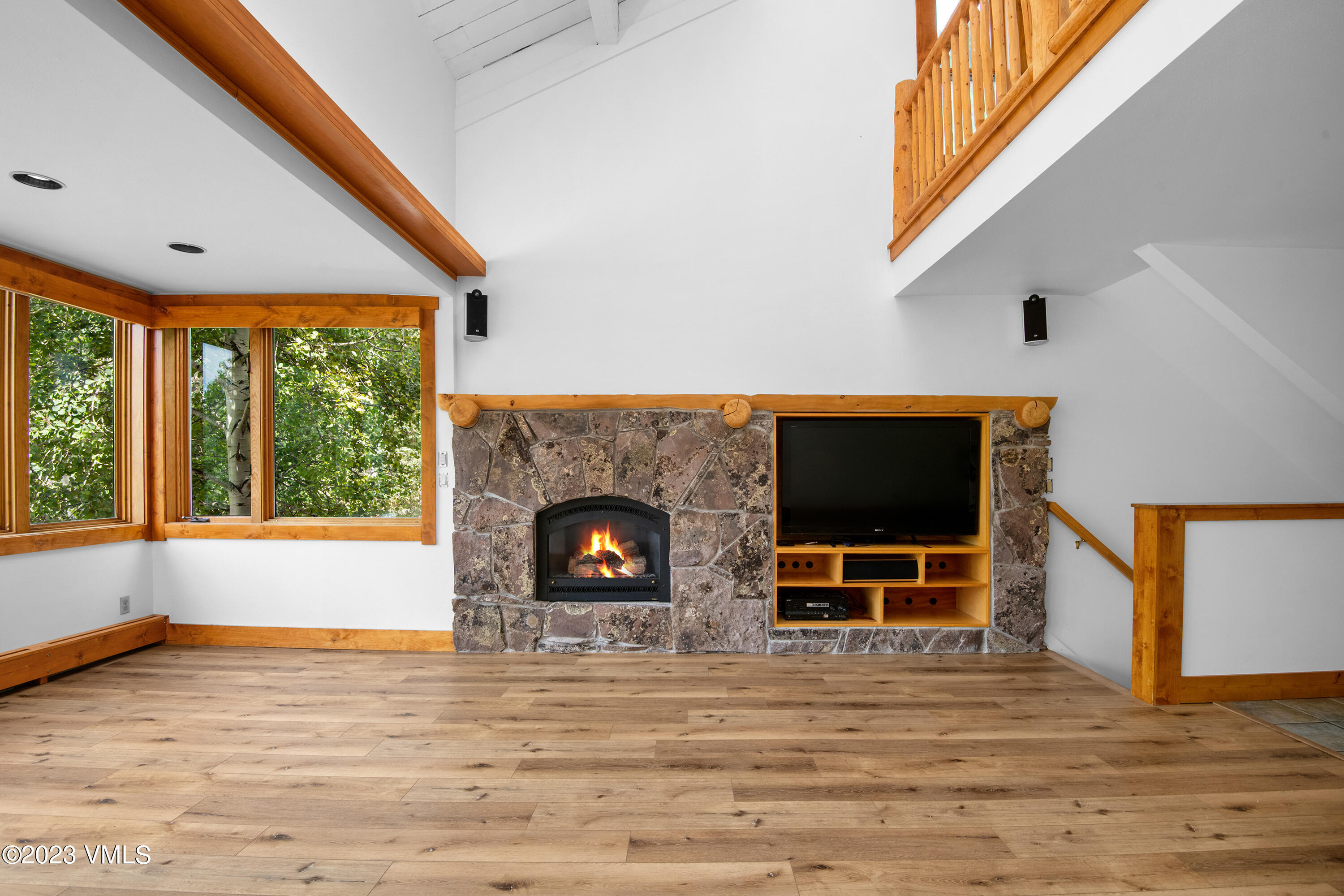 3094 Booth Falls Road, Unit 17 Vail, CO 81657 - Photo 3 of 27 a living room with fireplace and a floor to ceiling window