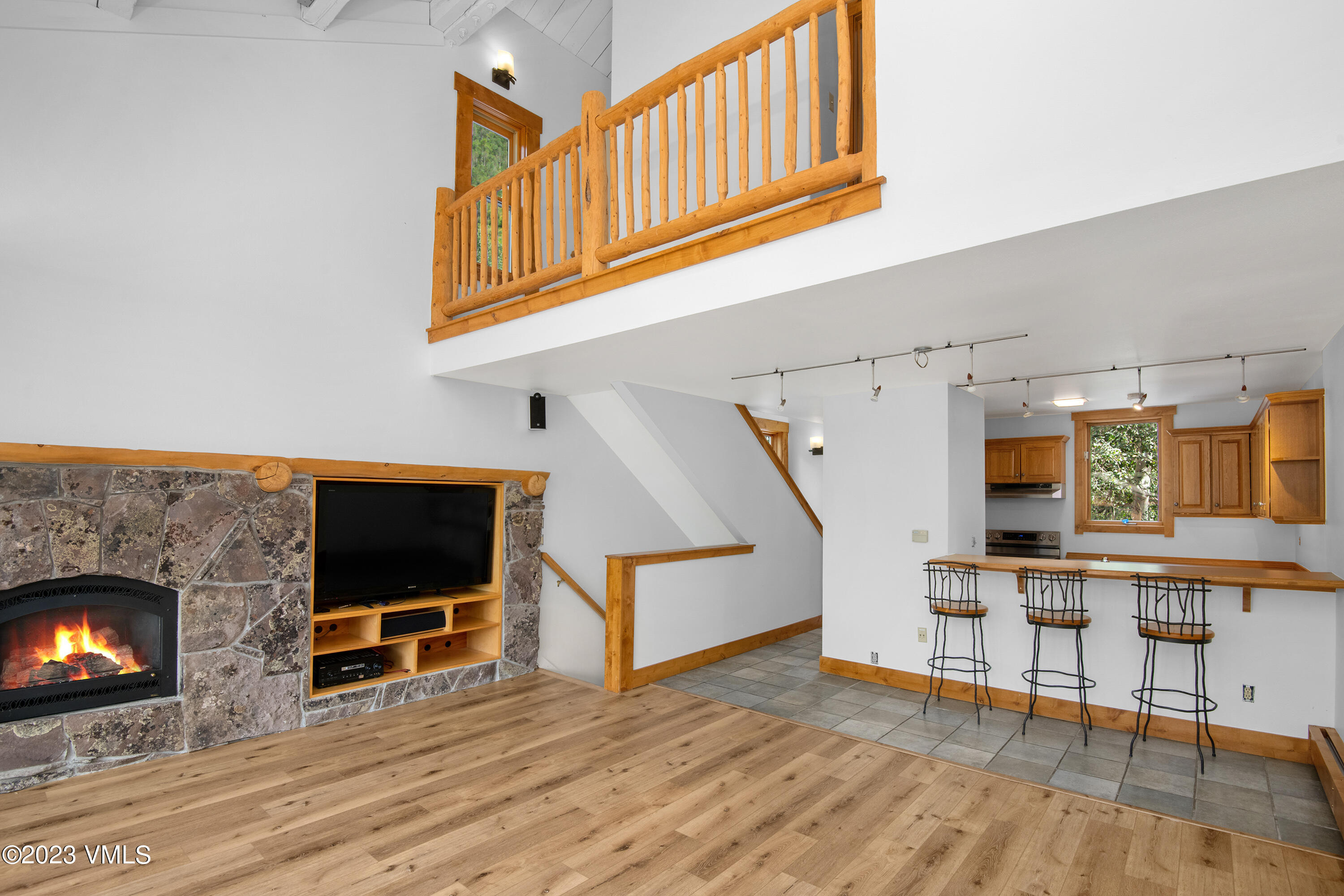3094 Booth Falls Road, Unit 17 Vail, CO 81657 - Photo 6 of 27 a living room with furniture flat screen tv and a fireplace