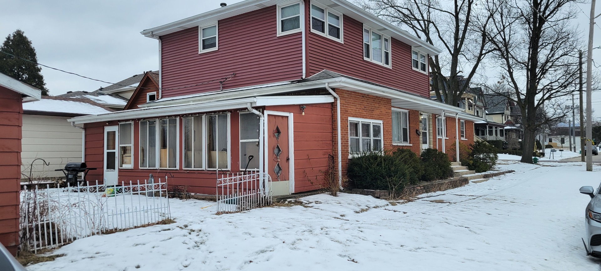 927 Walter Street Lemont, IL 60439 - Photo 3 of 16 a view of a house with wooden fence next to a road