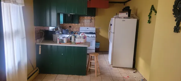 a room with cabinets and a refrigerator