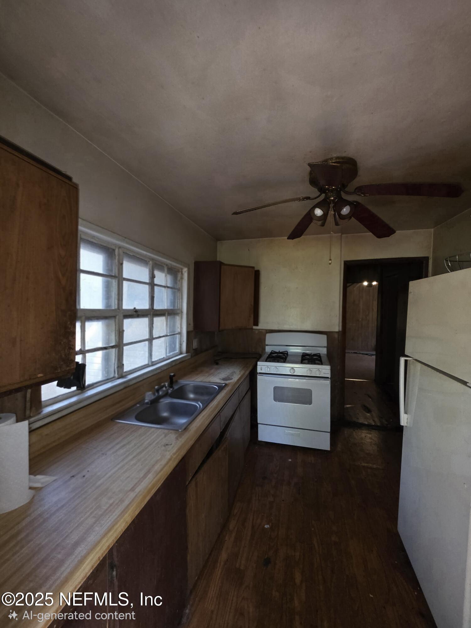 306 Green Avenue Live Oak, FL 32064 - Photo 2 of 6 a kitchen with a refrigerator and a stove