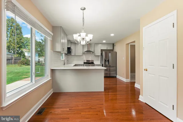 a view of a kitchen with a sink stainless steel appliances and cabinets