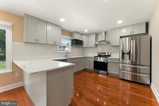 a kitchen with a refrigerator sink and cabinets