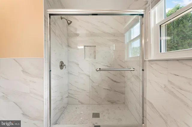 a bathroom with a glass shower door