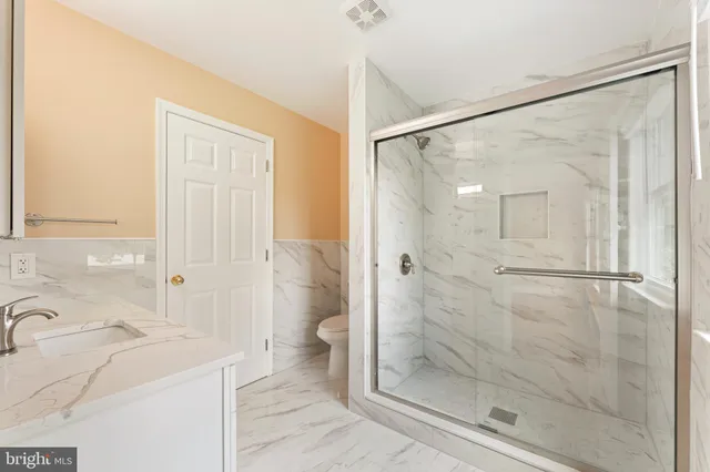 a bathroom with a shower sink and mirror