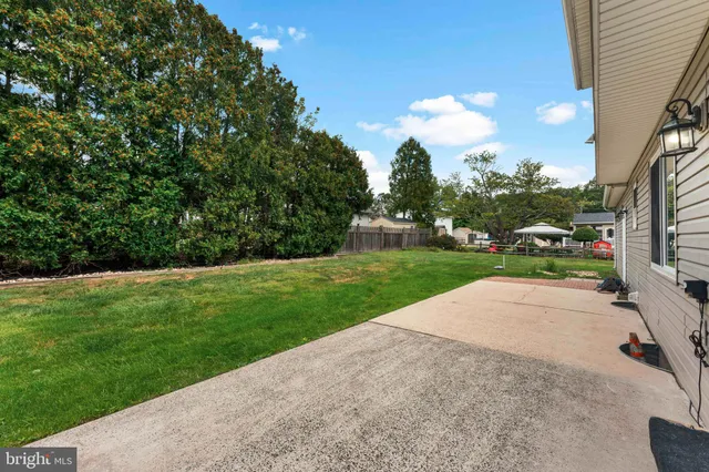 a view of a street with next to a yard